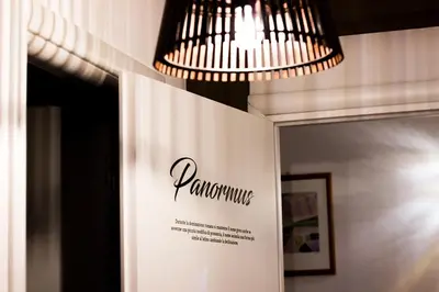 a chandelier hangs above a sign on a wall at B&B Gallidoro in Palermo