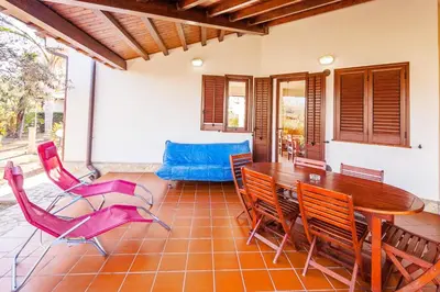 a dining room with a table and chairs at Sole Mare Deluxe in Campofelice di Roccella