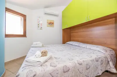 a bedroom with a bed with towels on it at Sole Mare Deluxe in Campofelice di Roccella