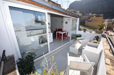 a balcony with a table and chairs on a building at Terrazza in Palazzo Taormina in Castellammare del Golfo
