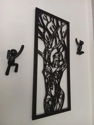 a black mirror hanging on a wall with two black cats at 