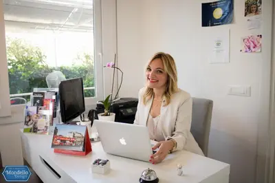 a woman sitting at a desk with a laptop computer at B&B Mondello Design in Mondello