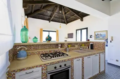 a kitchen with a stove and a sink at Dune Home alloggi sul mare in Alcamo Marina