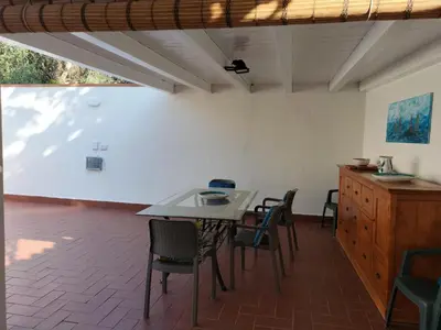 a dining room with a table and chairs at Green Space Apartment in Mondello