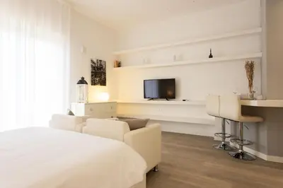 a bedroom with a bed and a tv on a wall at Palermo ai Leoni in Palermo