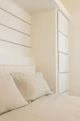 a white bedroom with a bed and a window at Palermo ai Leoni in Palermo