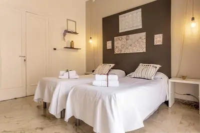 two beds sitting next to each other in a room at MassimoCentro Rooms in Palermo