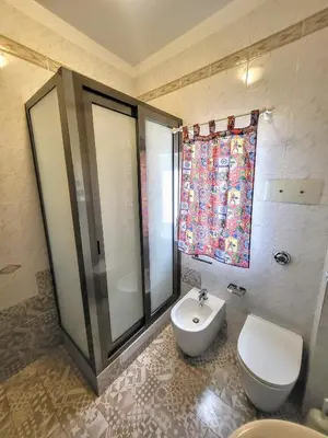 a bathroom with a toilet and a sink and a shower at Seafront House Gabbiano Azzurro in Santa Flavia