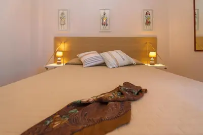 a bedroom with a large bed with two lamps at Dimore di mare - Beachfront Apartments in Santa Flavia
