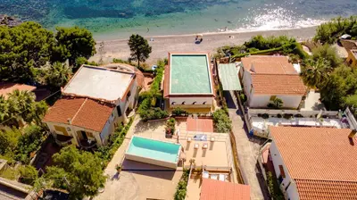 an aerial view of a beach with houses and a swimming pool at Dimore di mare - Beachfront Apartments in Santa Flavia