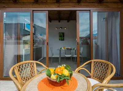 a table with a bowl of fruit on it at Arricàmpati Airport Rooms & Bringo Car Rental in Carini