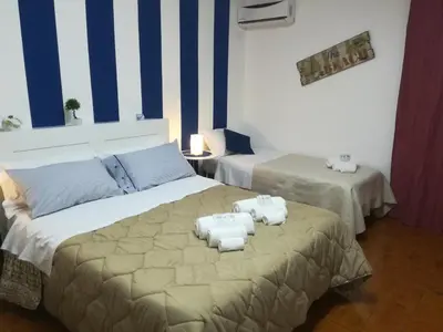 a bedroom with two beds with towels on it at La Dimora dei sette Arcangeli in Palermo