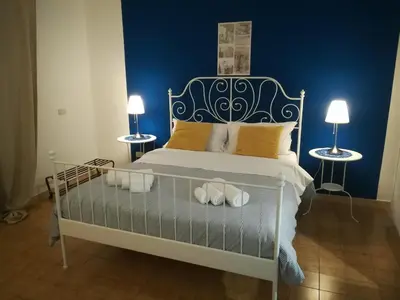 a bedroom with a bed with two side tables at La Dimora dei sette Arcangeli in Palermo