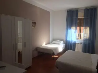 a small bedroom with two beds and a window at La Dimora dei sette Arcangeli in Palermo