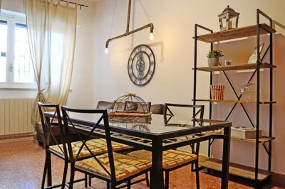 a dining room with a glass table and chairs at Piazza Marina in Palermo