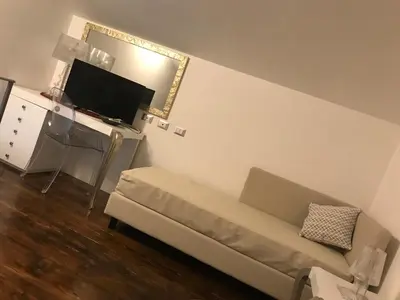 a living room with a couch and a flat screen tv at B&B Timpe Bianche in Castelluzzo