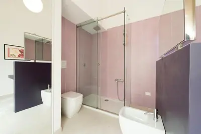 a bathroom with a shower and a toilet and a sink at Gattopardo Apartments - LAGO Design by Wonderful Italy in Palermo