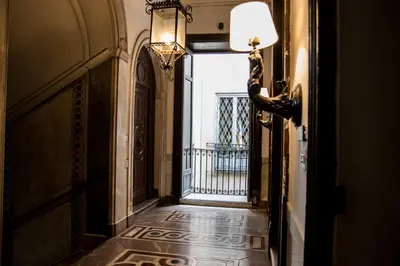 a hallway with an open door to a balcony at Balate Maqueda B&B in Palermo
