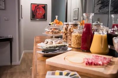 a wooden table with food and drinks on it at Balate Maqueda B&B in Palermo
