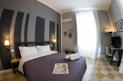a bedroom with a large bed and a window at Balate Maqueda B&B in Palermo