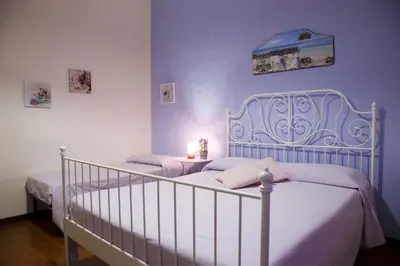 a bedroom with two beds and a candle on a table at Vista sul porto in Palermo