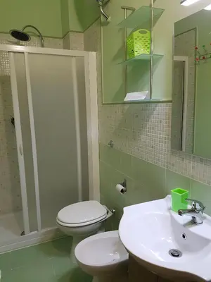 a bathroom with a white toilet and a sink at Vista sul porto in Palermo