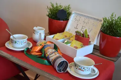 a table with two cups of tea and a box of plants at Vista sul porto in Palermo
