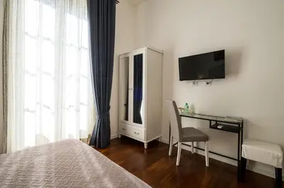 a hotel room with a desk and a television at Ai Lattarini House in Palermo