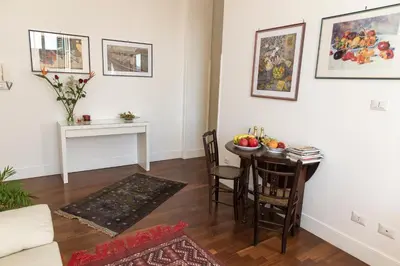 a living room with a dining room table and a table at Ai Lattarini House in Palermo