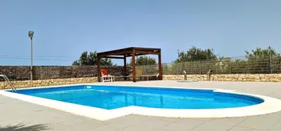 a swimming pool in a yard with a gazebo at Villa Paradiso in Alcamo Marina