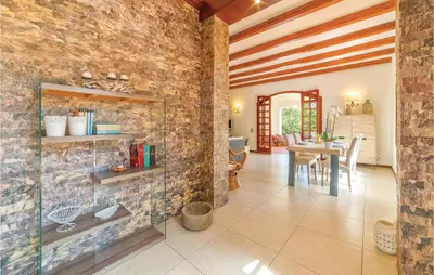 a living room with a stone wall and a table at Villa Belvedere in Sambuca di Sicilia