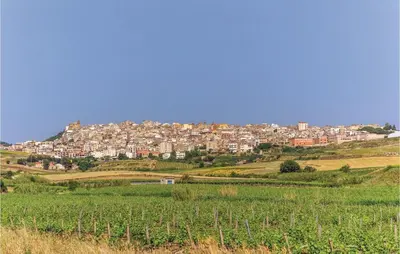 a town on top of a hill with a green field at Villa Belvedere in Sambuca di Sicilia