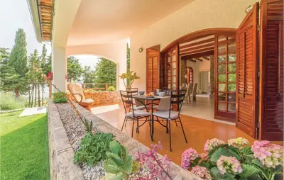 a home with a patio with a table and chairs at Villa Belvedere in Sambuca di Sicilia