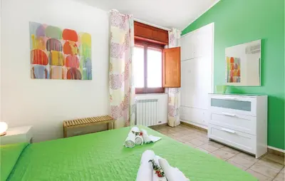 a bedroom with a green bed and a window at Villa Belvedere in Castellammare del Golfo