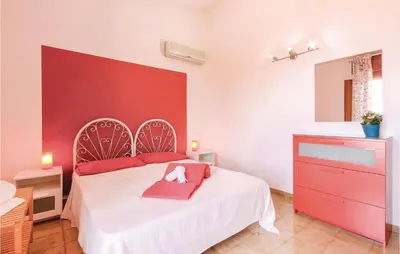 a bedroom with a white bed and a red wall at Villa Belvedere in Castellammare del Golfo