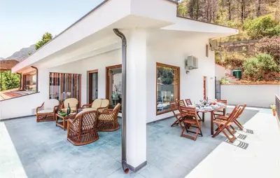 a patio with a table and chairs on it at Villa Belvedere in Castellammare del Golfo