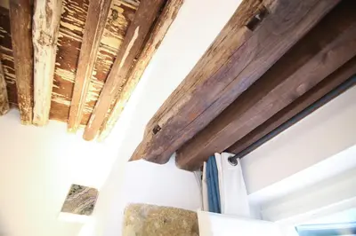 a room with wooden beams on the ceiling at Bedda Mari Rooms & Suite in Palermo