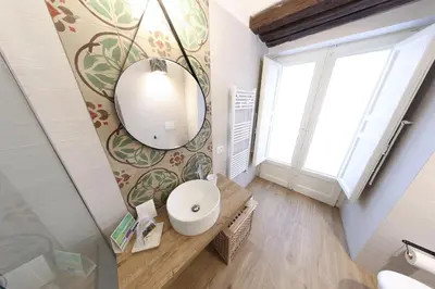 a bathroom with a mirror and a sink at Bedda Mari Rooms & Suite in Palermo