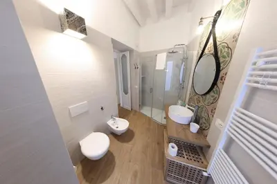 a bathroom with two sinks and a shower at Bedda Mari Rooms & Suite in Palermo