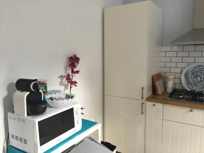a microwave sitting on top of a table in a kitchen at Casa Azzurra by Un mare di Blu in Macari