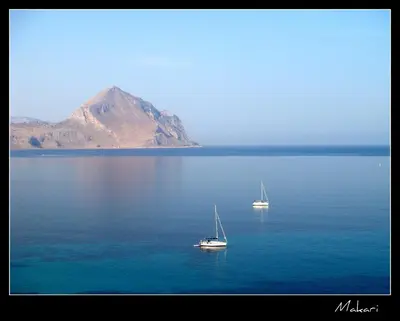 two boats in a large body of water with a mountain at Casa Azzurra by Un mare di Blu in Macari