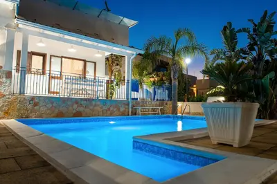 a villa with a swimming pool at night at Villa Oleandro in Alcamo Marina