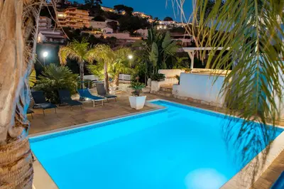 a swimming pool in a resort at night at Villa Oleandro in Alcamo Marina