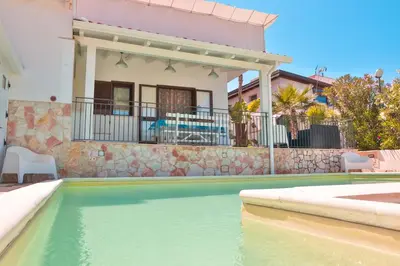 a house with a swimming pool in front of a house at Villa Oleandro in Alcamo Marina