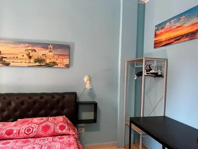 a bedroom with a bed and a picture on the wall at Belmonte Blu Suite in Palermo