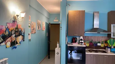 a kitchen with blue walls and a stove top oven at Belmonte Blu Suite in Palermo
