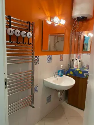 a bathroom with a sink and a mirror at Belmonte Blu Suite in Palermo