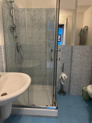 a bathroom with a shower and a sink at Belmonte Blu Suite in Palermo