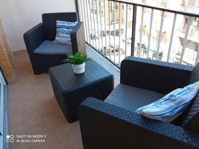 a balcony with two chairs and a table with a potted plant at Casa del Cioccolato in Palermo