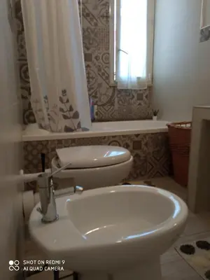 a bathroom with a white sink and a toilet at Casa del Cioccolato in Palermo